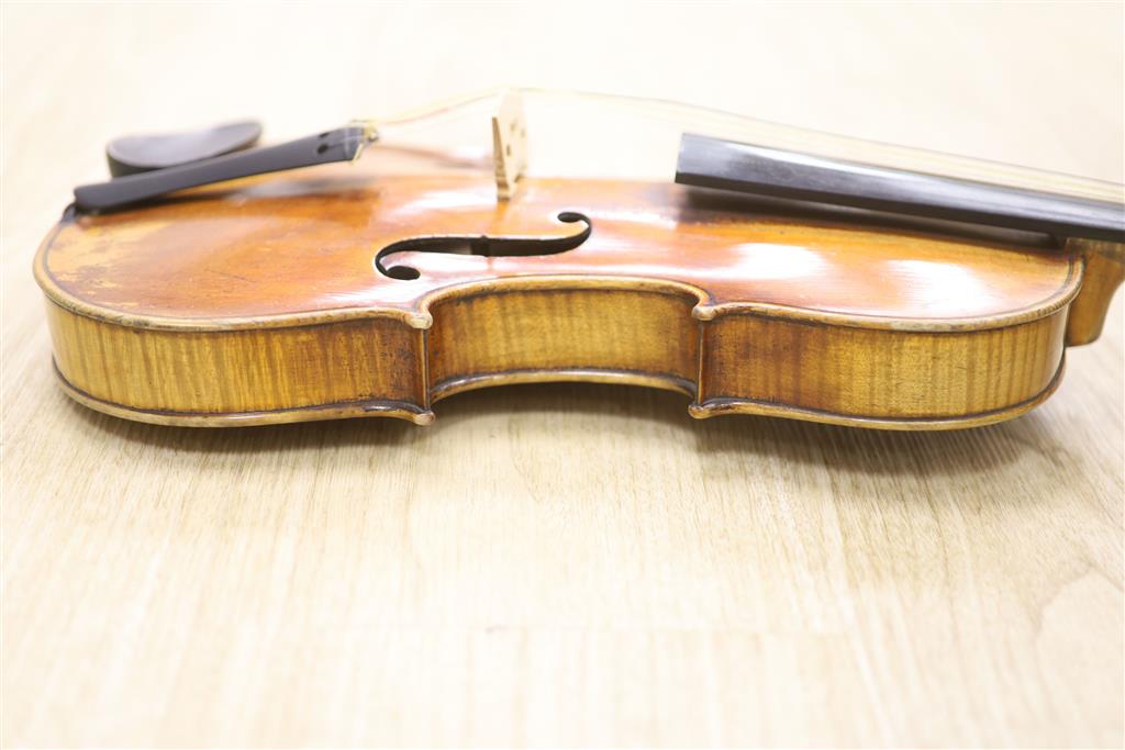 A late 19th century violin and a bow, cased
